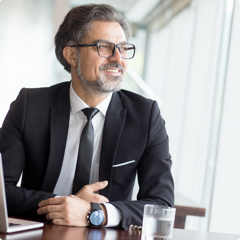 Professional man sitting at table smiling