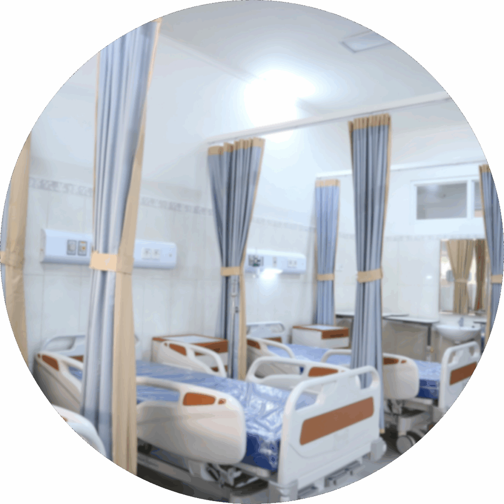 An NHS ward with hospital beds and curtains